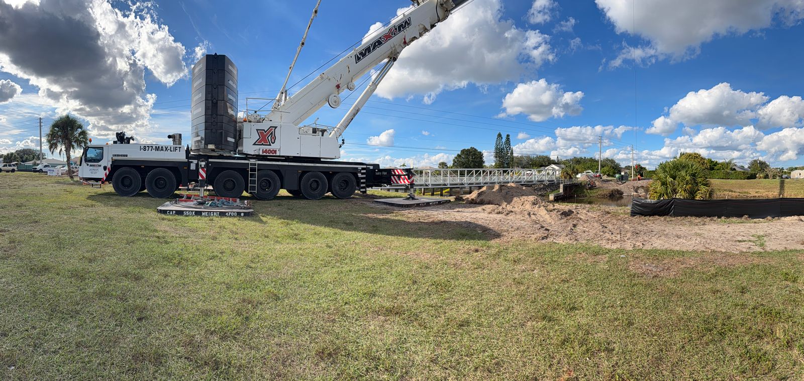 Mobile crane supporting lift operations near a civil work site
